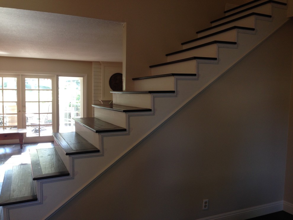 Photo of a medium sized traditional painted wood straight staircase in Orange County with painted wood risers.