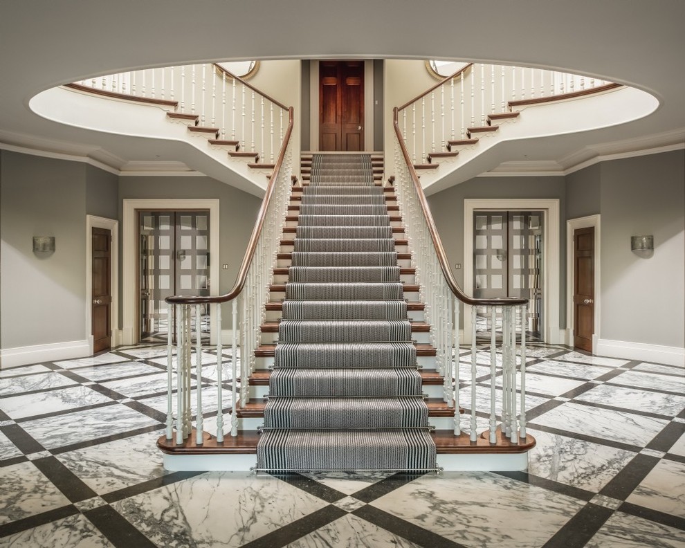 Photo of a medium sized classic carpeted wood railing staircase in Surrey with carpeted risers.