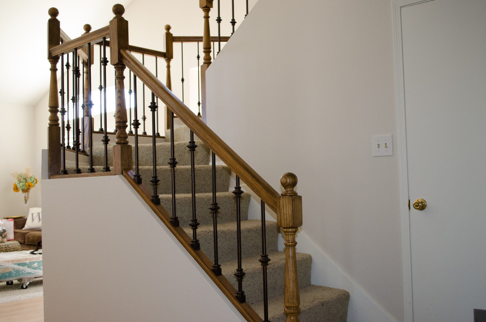 Example of a mid-sized transitional carpeted u-shaped wood railing staircase design in Los Angeles with carpeted risers