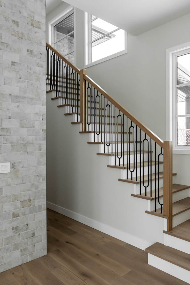 Example of a mid-sized minimalist wooden straight mixed material railing staircase design in Other with wooden risers