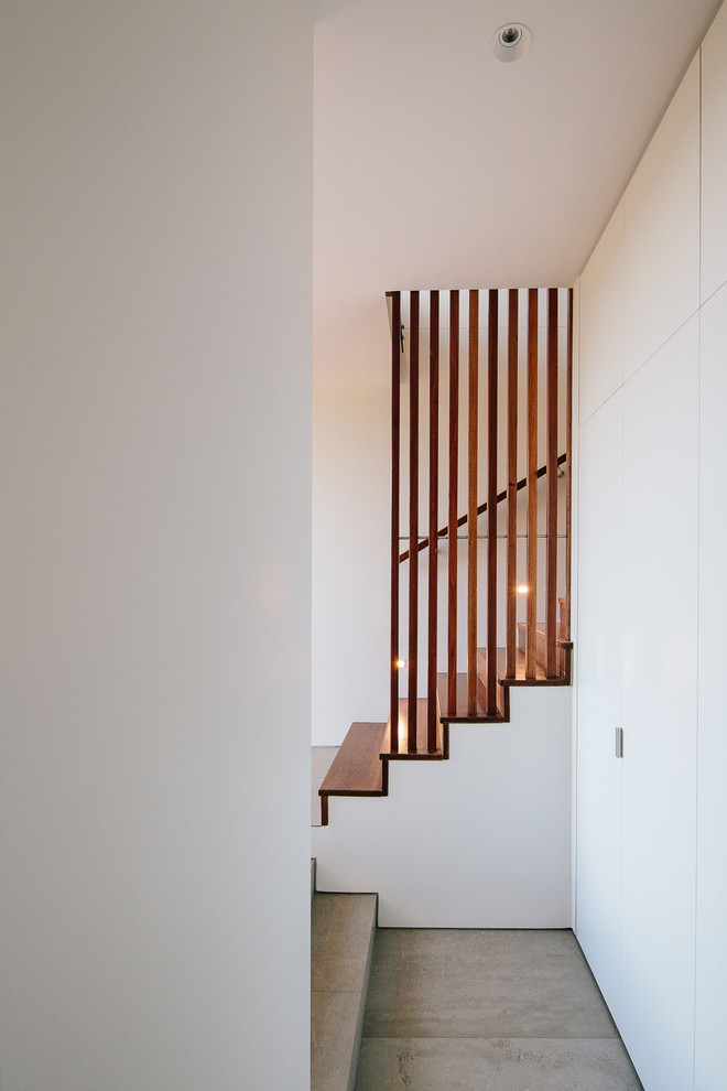 Design ideas for a medium sized modern wood straight wood railing staircase in Other with wood risers.