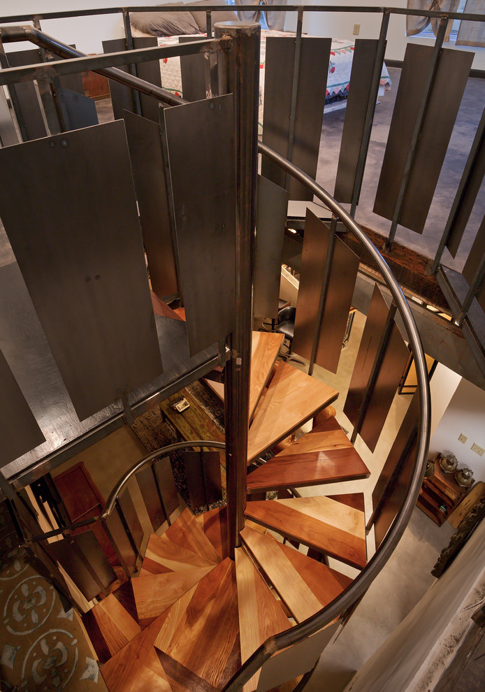 На фото: винтовая лестница среднего размера в стиле лофт с деревянными ступенями без подступенок