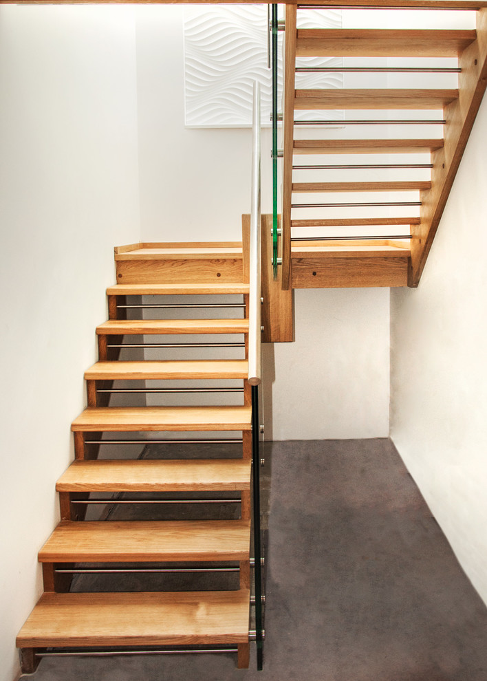 Esempio di una piccola scala a rampa dritta minimalista con pedata in legno, alzata in legno e parapetto in materiali misti