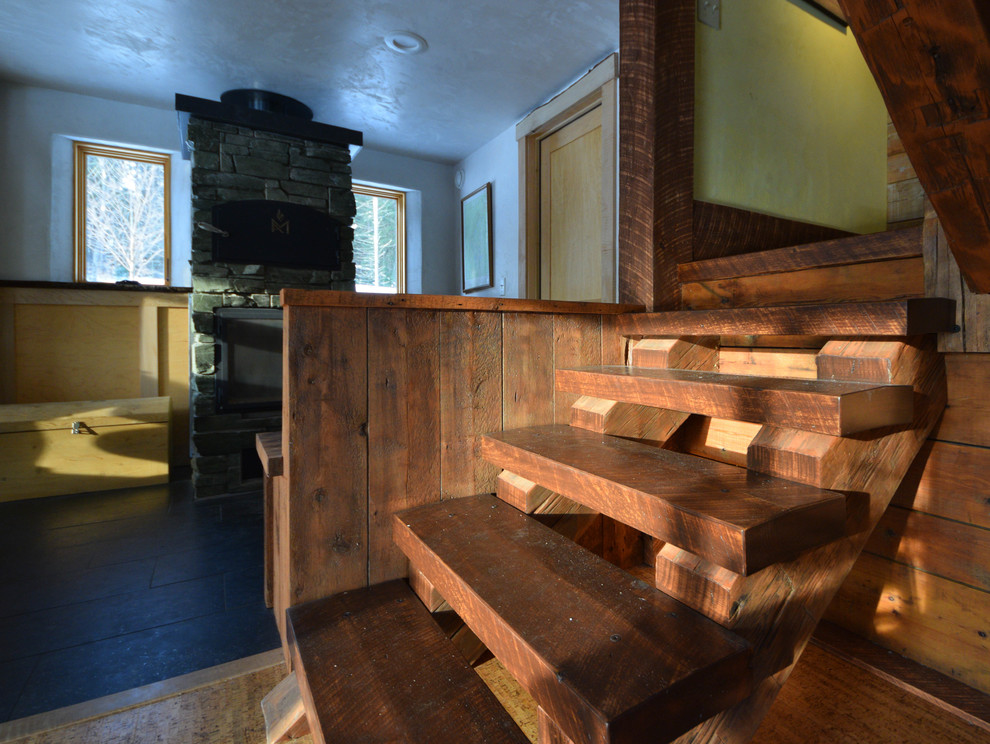 Inspiration for a small traditional wood l-shaped wood railing staircase in Burlington with open risers.