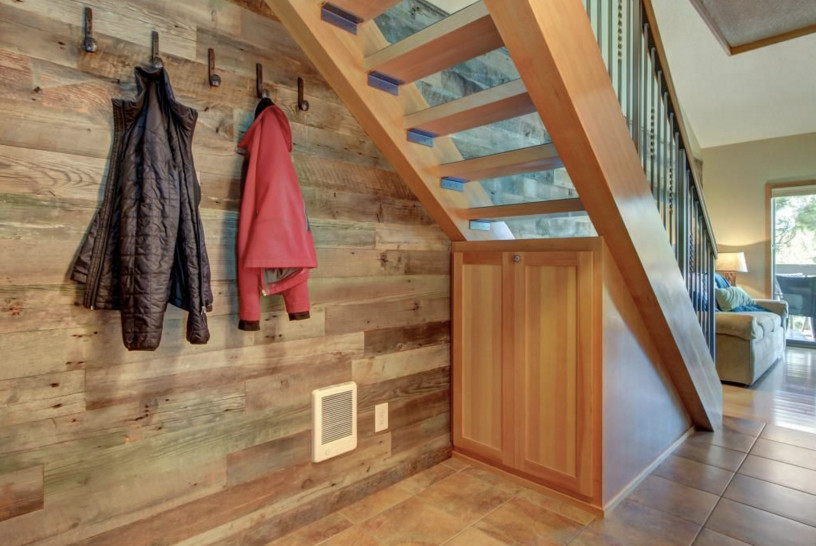 This is an example of a medium sized rustic wood straight mixed railing staircase in Other with feature lighting.