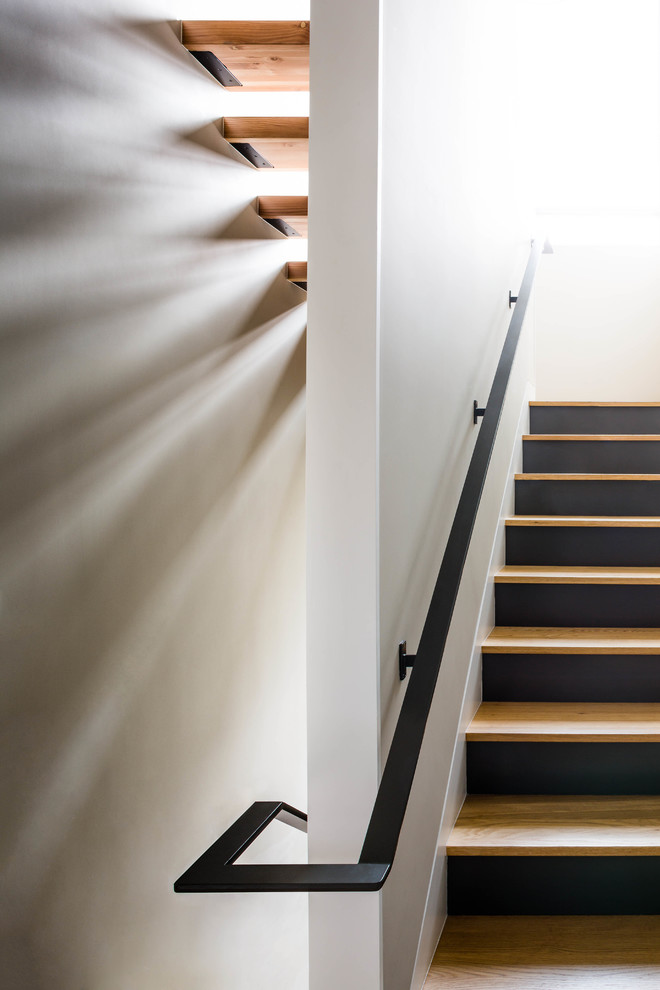 Design ideas for a contemporary wood staircase in Austin with wood risers.