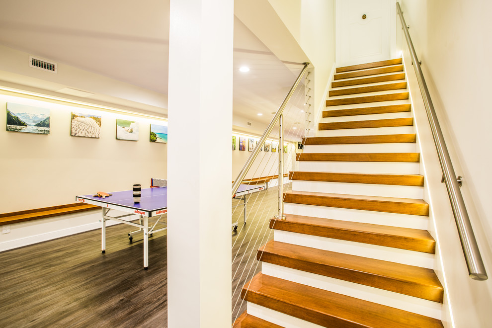 Photo of a medium sized contemporary wood straight wire cable railing staircase in New York with painted wood risers.