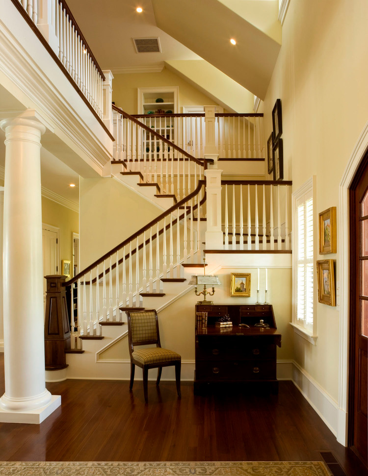 Design ideas for a large classic wood u-shaped staircase in Charleston with painted wood risers.