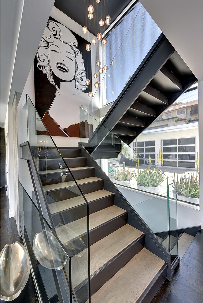Large contemporary wood floating staircase in Los Angeles with open risers.