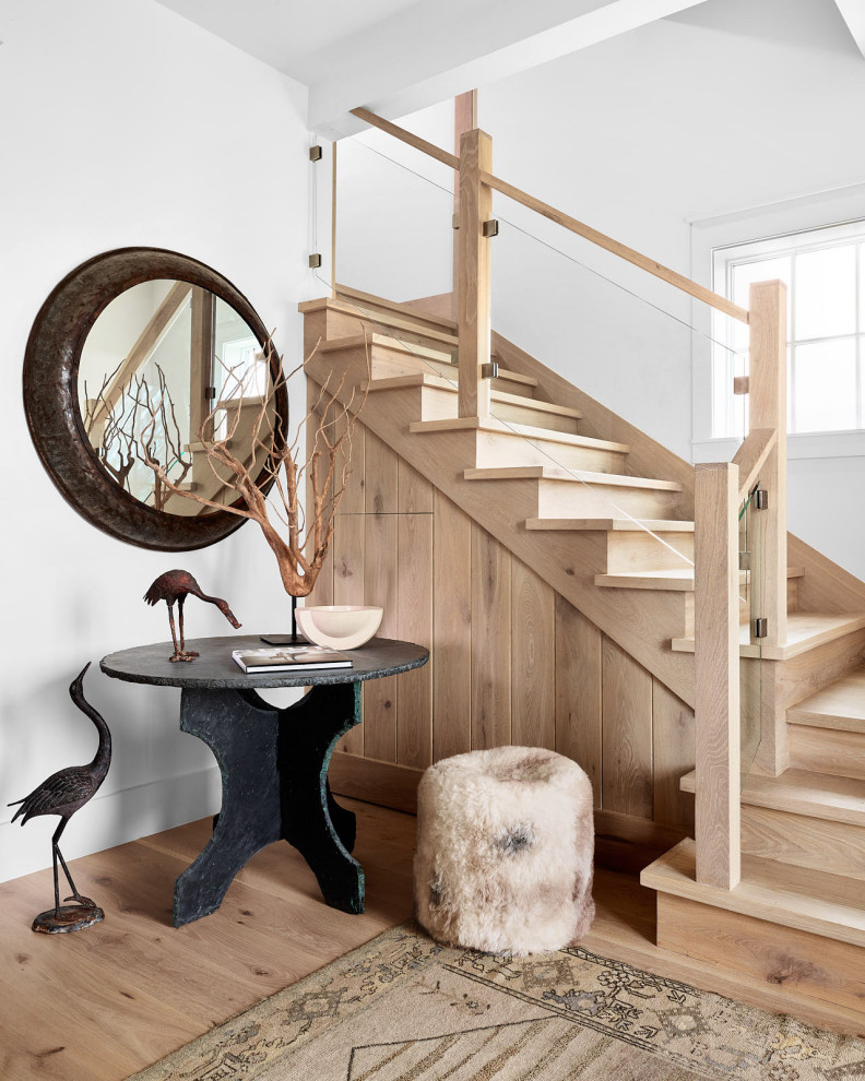 На фото: изогнутая деревянная лестница среднего размера в морском стиле с деревянными ступенями и деревянными перилами с
