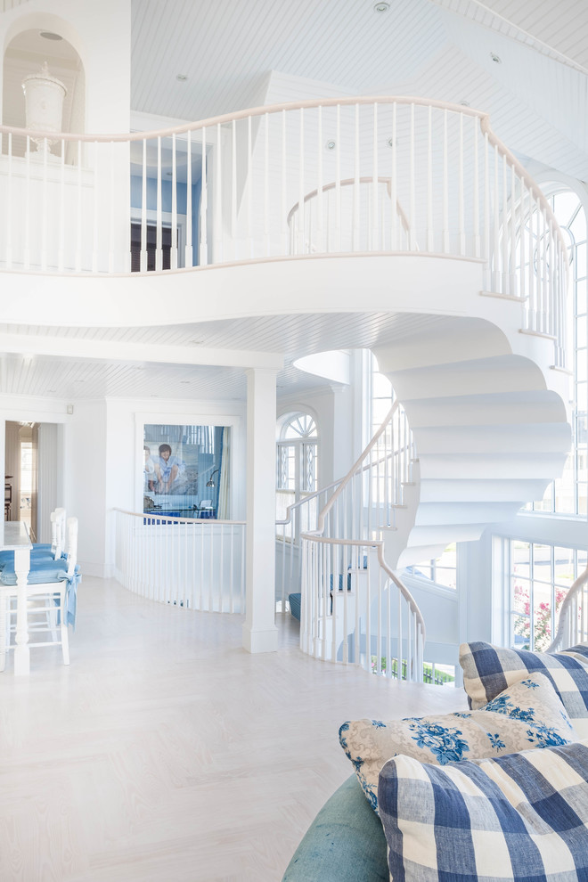 Design ideas for a beach style wood curved staircase in Philadelphia with painted wood risers.