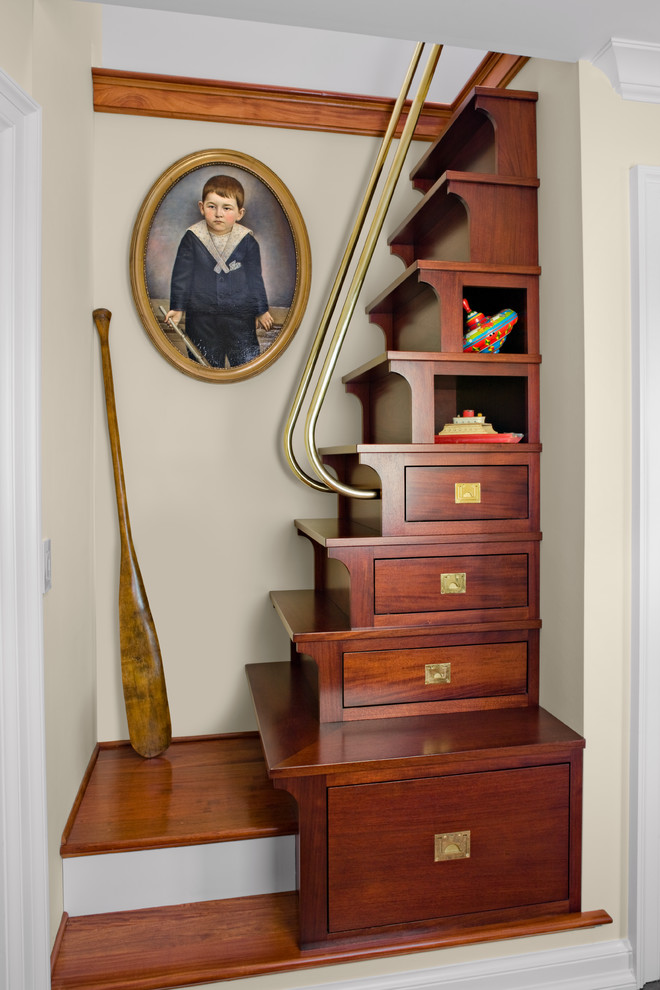 Photo of a small beach style wood straight staircase in New York with wood risers and under stair storage.
