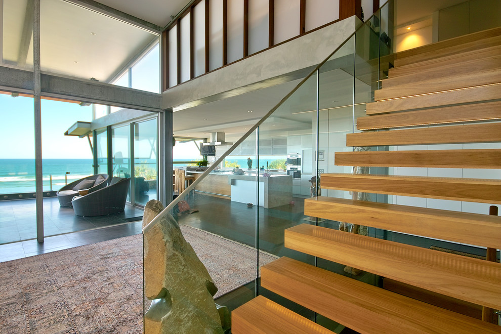 Photo of a beach style wood floating staircase in Brisbane.
