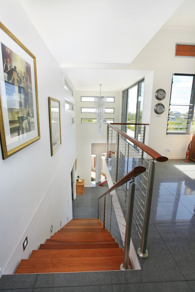 This is an example of a contemporary wood staircase in Sunshine Coast.