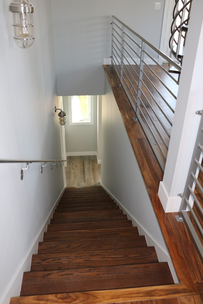 Example of a mid-sized transitional wooden straight metal railing staircase design in Orlando with painted risers