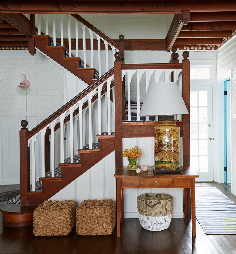 Example of a mid-sized beach style carpeted u-shaped wood railing staircase design in Portland Maine