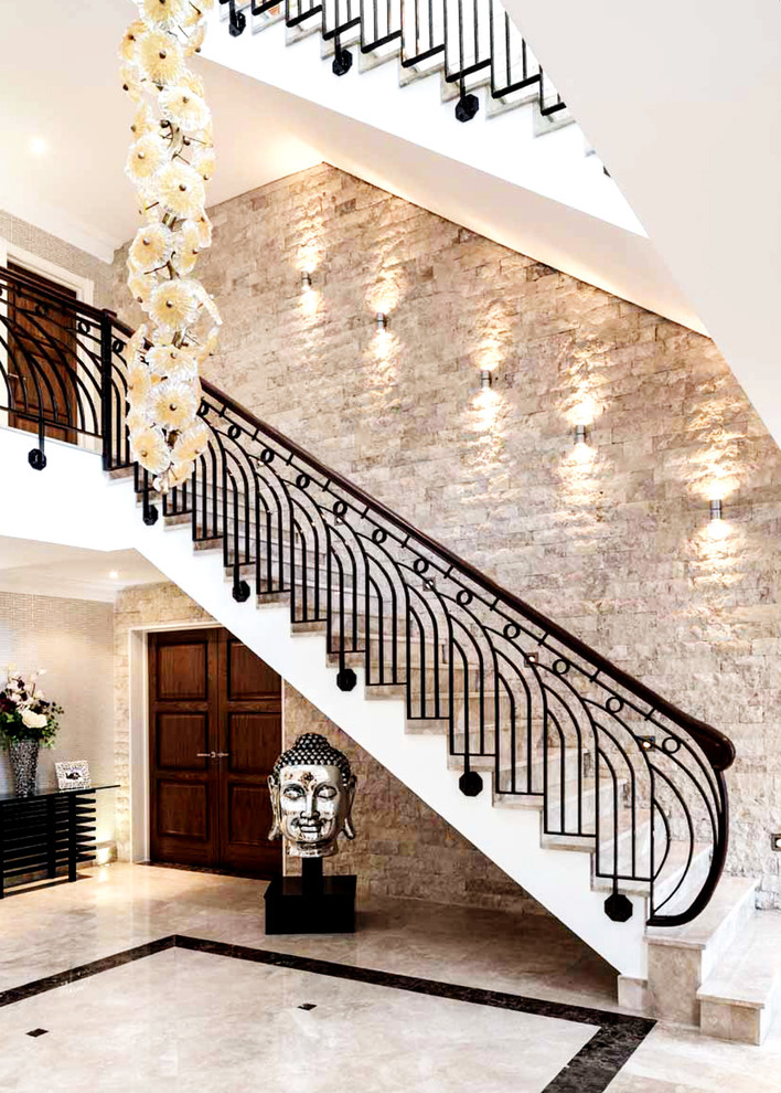 Photo of a large classic straight mixed railing staircase in Buckinghamshire with marble treads and marble risers.