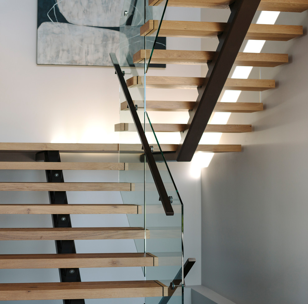 На фото: п-образная деревянная лестница среднего размера в современном стиле с деревянными ступенями и металлическими перилами