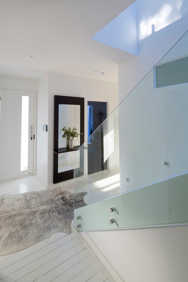 Example of a mid-sized trendy painted straight glass railing staircase design in Sydney with wooden risers