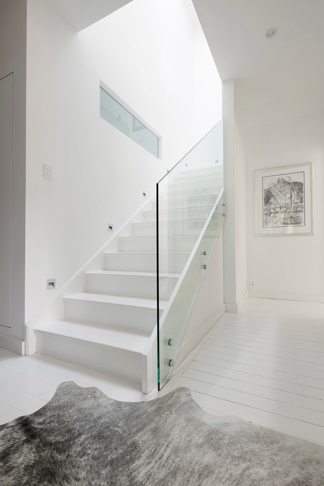 Staircase - mid-sized contemporary wooden straight glass railing staircase idea in Sydney with wooden risers