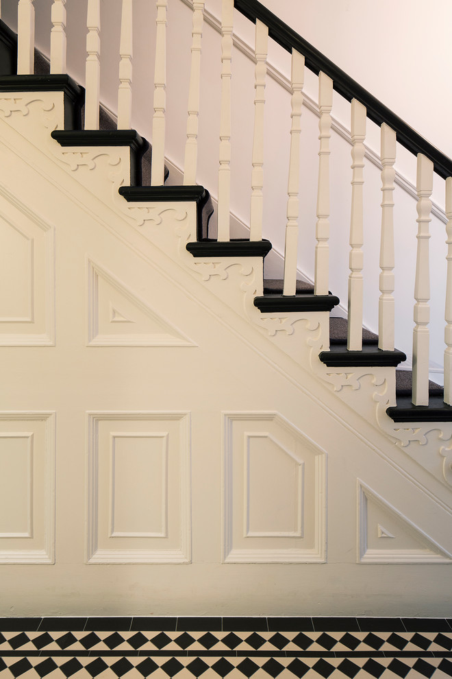 Inspiration for a mid-sized timeless painted u-shaped wood railing staircase remodel in London with painted risers