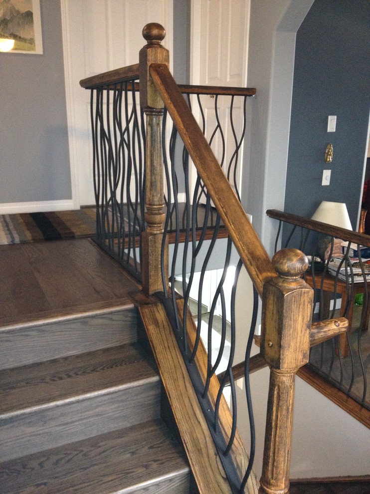 BENT iron design interior railing with a distressed wood handrail and ...