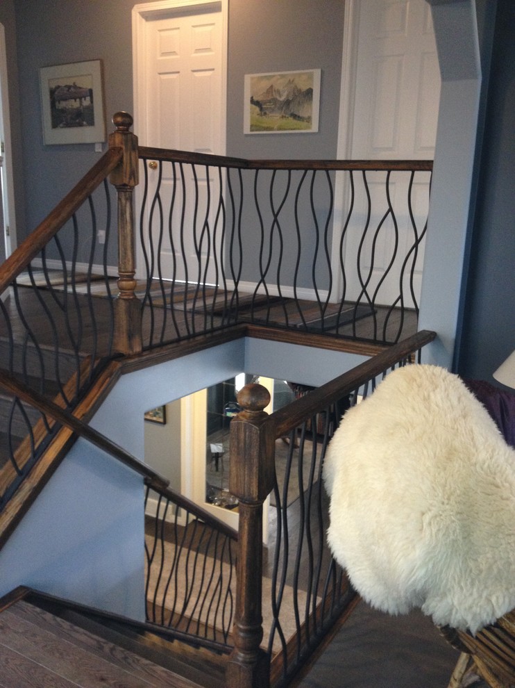 BENT iron design interior railing with a distressed wood handrail and ...