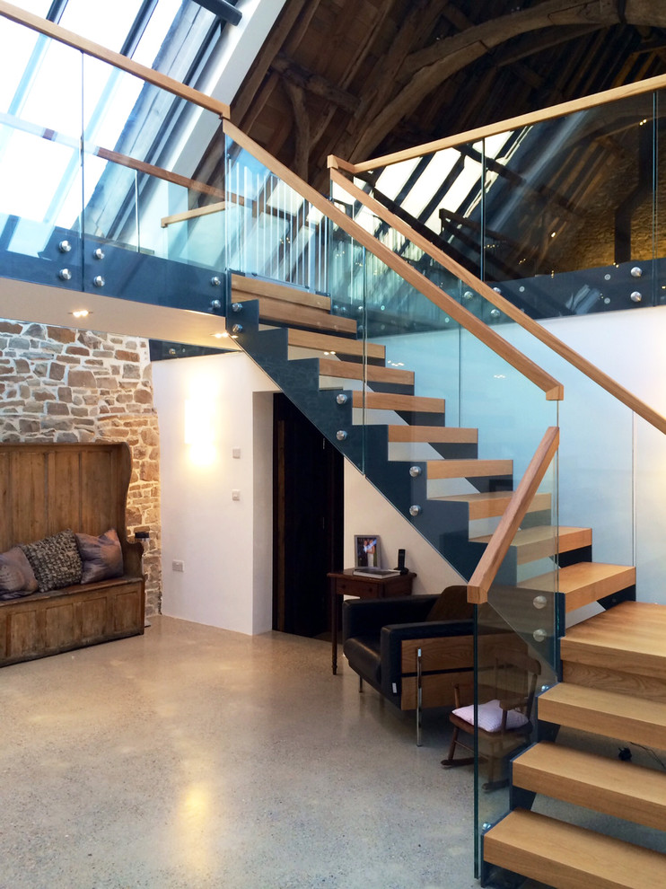 Inspiration pour un grand escalier sans contremarche design en L avec des marches en bois.