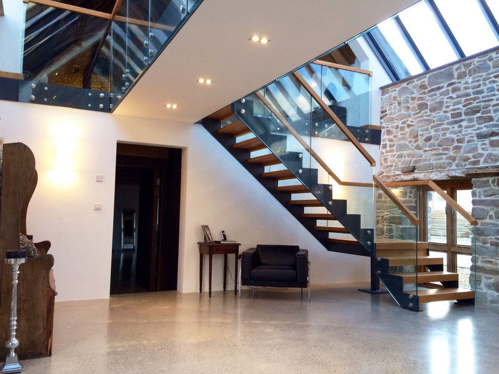 Large trendy wooden l-shaped open staircase photo in Hampshire
