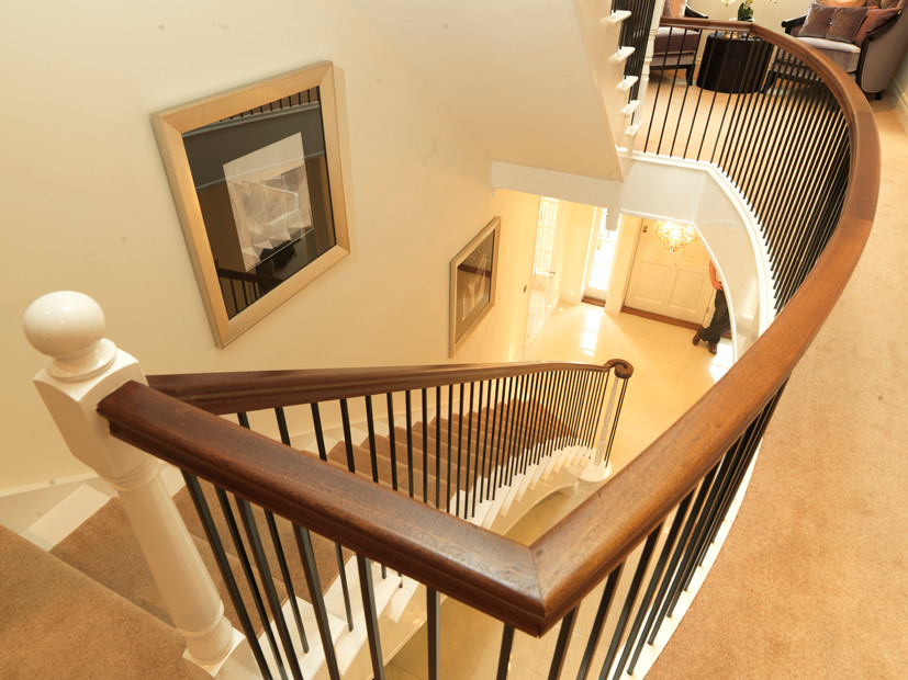 Staircase - large traditional painted curved staircase idea in Cambridgeshire with painted risers
