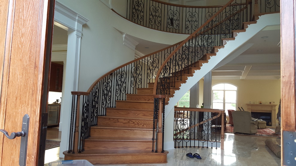 Staircase - large traditional wooden curved staircase idea in DC Metro with wooden risers