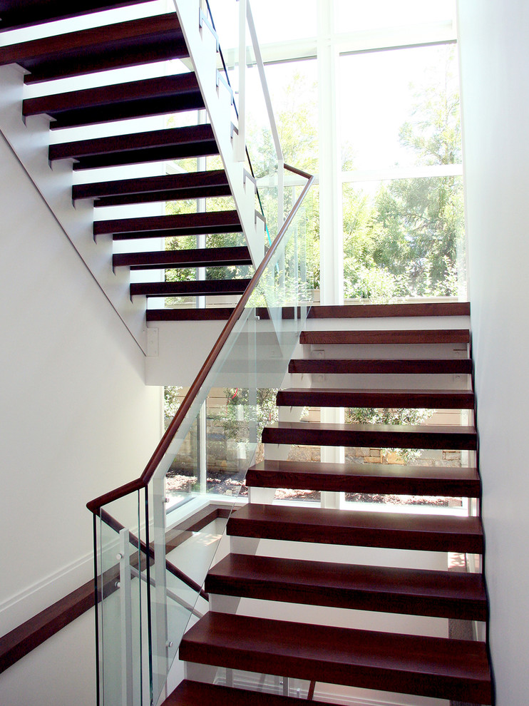Foto de escalera suspendida contemporánea de tamaño medio sin contrahuella con escalones de madera