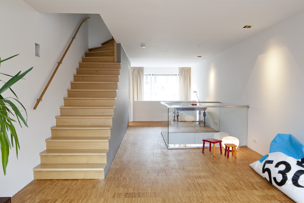 Inspiration for a contemporary wood staircase in Amsterdam with wood risers.