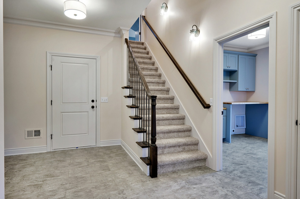 Идея дизайна: большая прямая лестница в классическом стиле с ступенями с ковровым покрытием, ковровыми подступенками и деревянными перилами