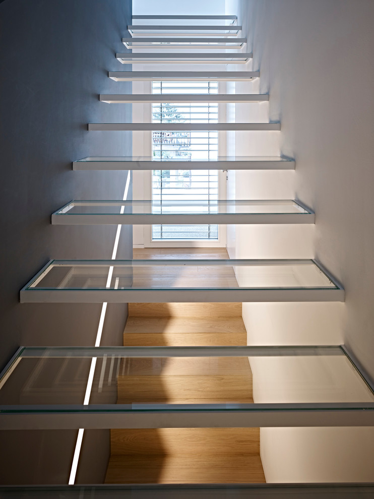 Inspiration for a contemporary glass floating staircase in Other with open risers.