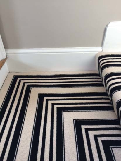 Inspiration for a contemporary carpeted u-shaped staircase remodel in London with carpeted risers