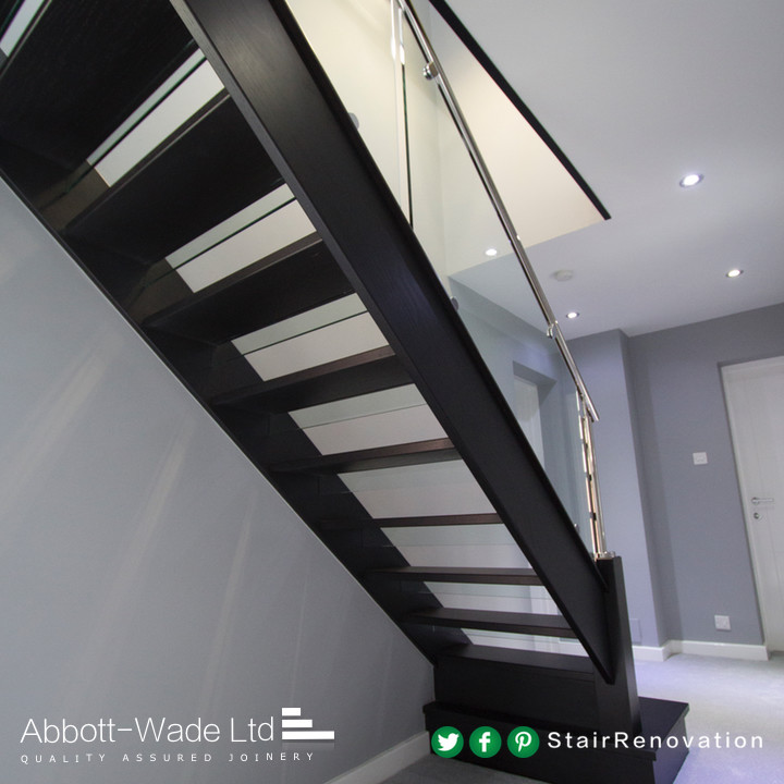 This is an example of a painted wood staircase in Cheshire with glass risers.