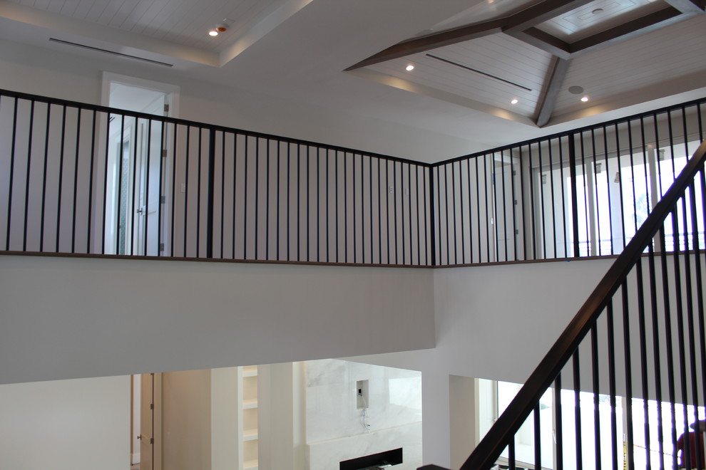 This is an example of a medium sized traditional wood l-shaped metal railing staircase in Other with wood risers.