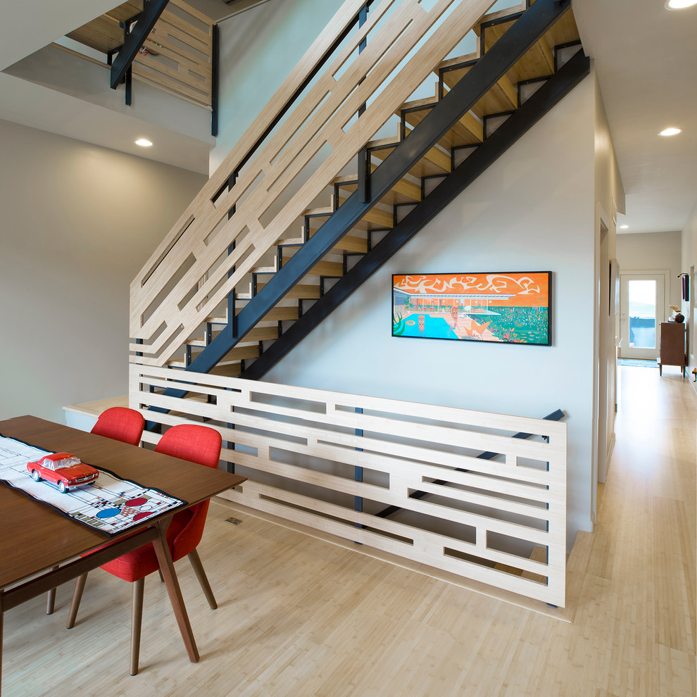 Photo of a contemporary wood straight wood railing staircase in St Louis with open risers.