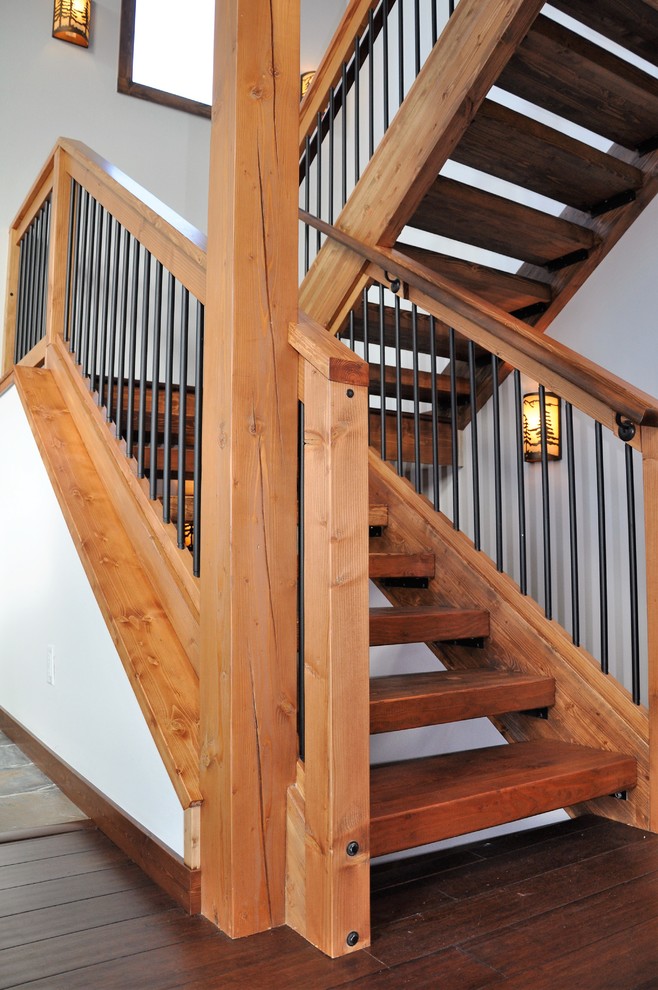 Staircase - mid-sized rustic wooden u-shaped wood railing staircase idea in Denver with wooden risers