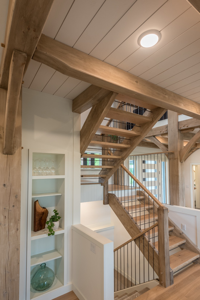 Diseño de escalera en U rústica de tamaño medio sin contrahuella con escalones de madera y barandilla de varios materiales