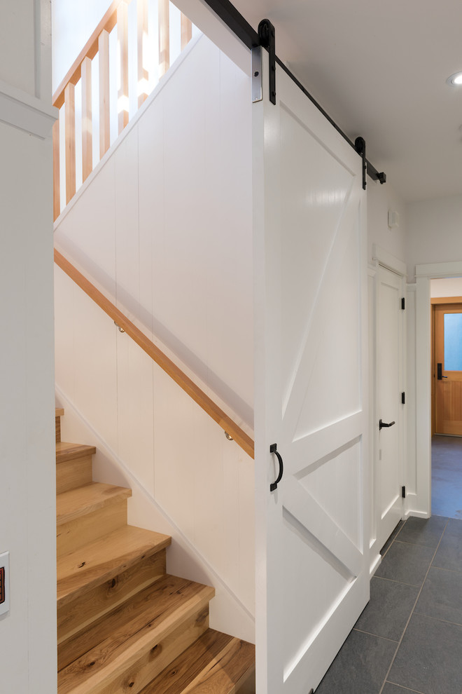 Design ideas for a medium sized farmhouse wood u-shaped staircase in Vancouver with wood risers.