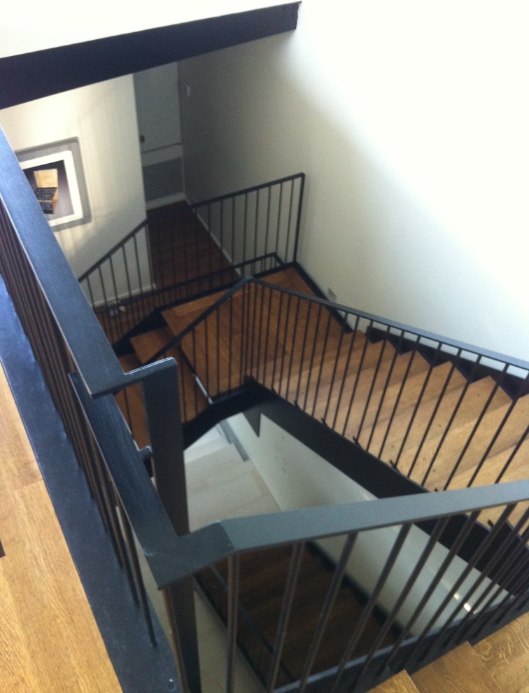 Inspiration for a mid-sized contemporary metal l-shaped staircase remodel in Austin with wooden risers