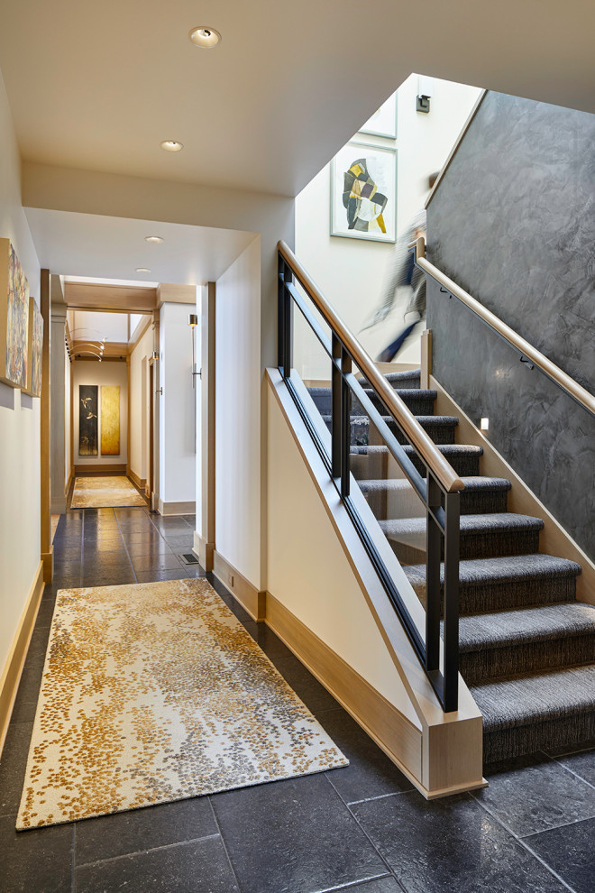 Example of a transitional carpeted u-shaped metal railing staircase design in Seattle with carpeted risers