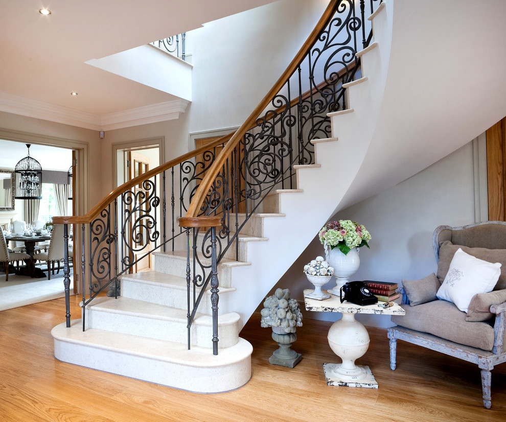 Photo of a large traditional curved staircase in Berkshire.