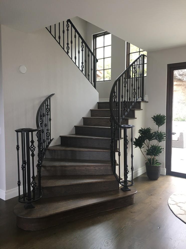 Staircase - large mediterranean wooden curved staircase idea in Orange County