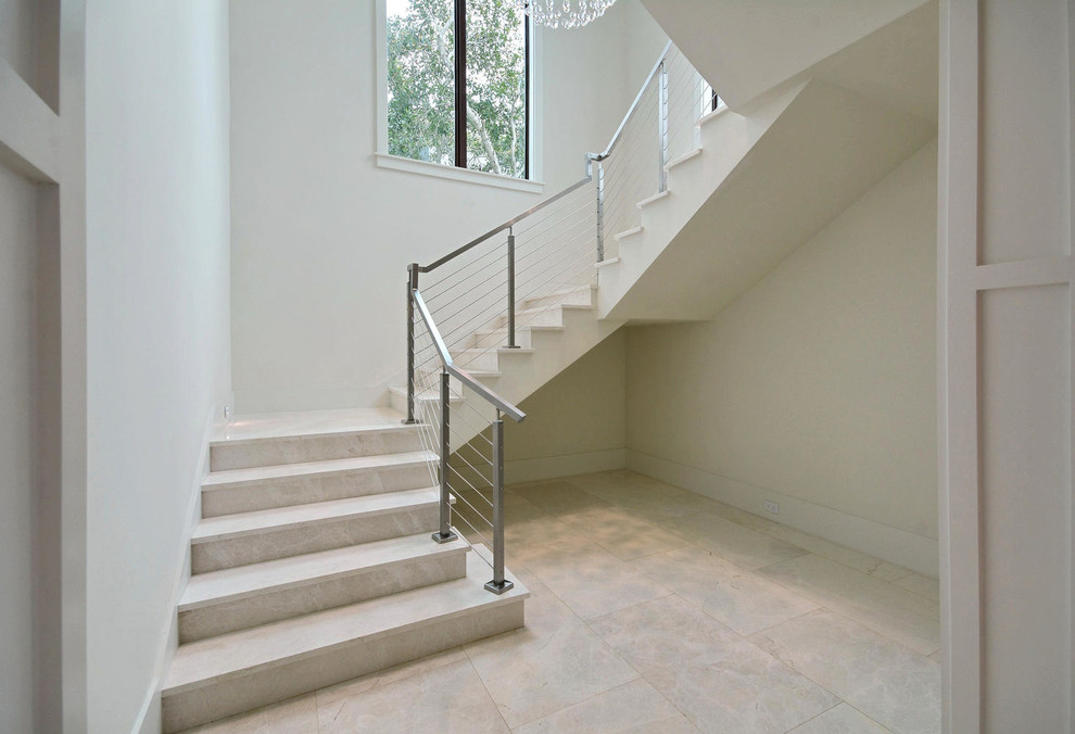 Medium sized contemporary u-shaped staircase in Miami with marble treads and marble risers.