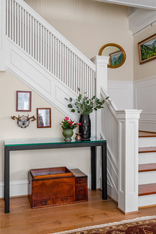 Medium sized bohemian wood l-shaped wood railing staircase in Seattle with painted wood risers.