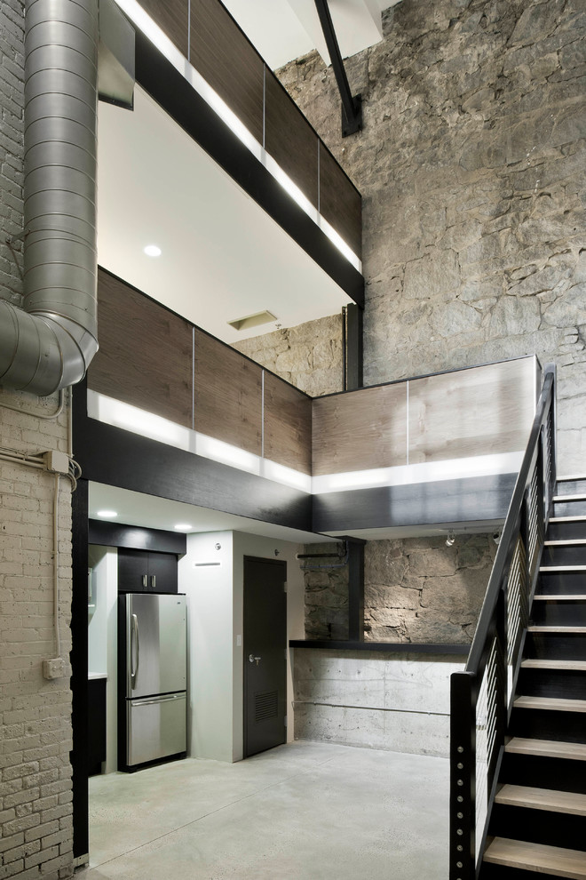 Cette image montre un escalier droit minimaliste en béton de taille moyenne avec des contremarches en métal.