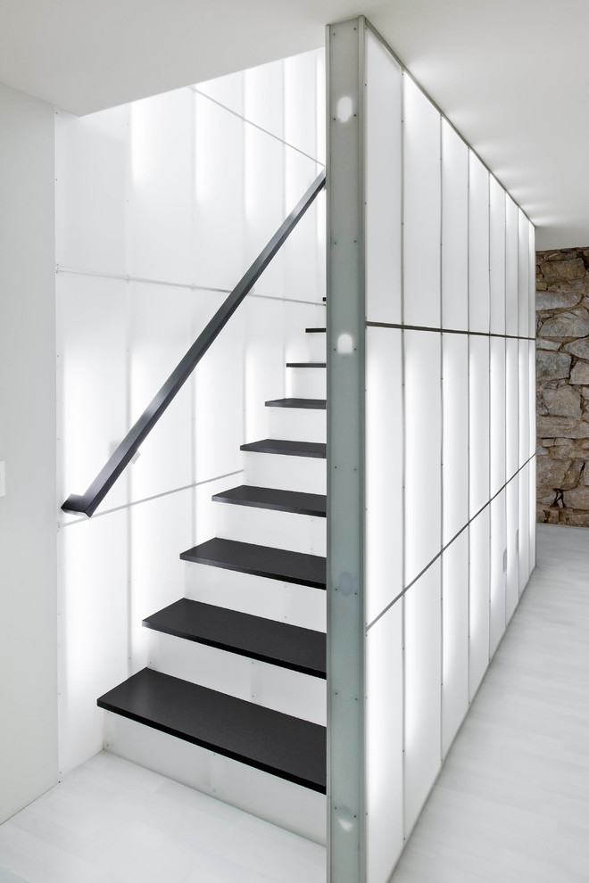 Photo of a medium sized contemporary wood straight staircase in Boston with metal risers.